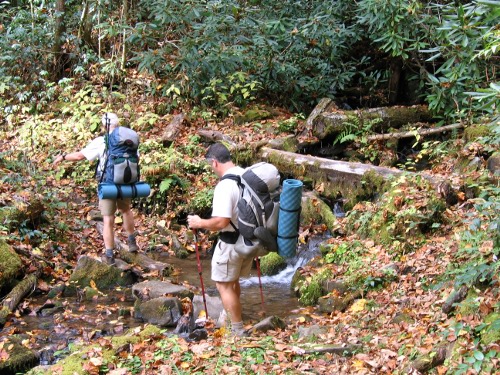 Dad and Craig cross a creek.